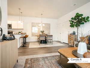 Living room featuring hardwood / wood-style flooring and an inviting chandelier