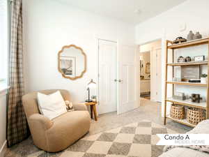 Living area featuring light colored carpet