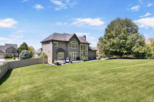 Back of property featuring outdoor lounge area and a yard