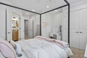 Carpeted bedroom featuring sink and ceiling fan