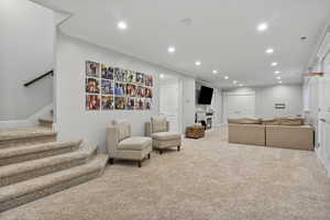 Living room featuring ornamental molding and light colored carpet