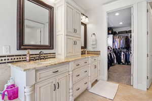 Bathroom featuring tile patterned floors and vanity