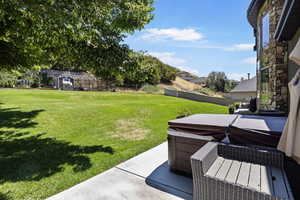 View of yard with a hot tub