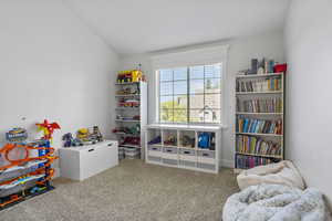 Game room featuring carpet and lofted ceiling