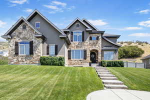 Craftsman-style home with a front lawn