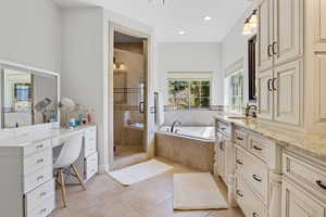 Bathroom with plus walk in shower, vanity, and tile patterned floors