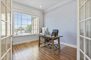 Office space featuring wood-type flooring, ornamental molding, and french doors