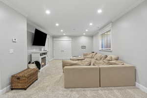 Family  room with carpet floors and crown molding