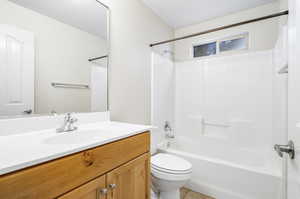 Full bathroom featuring tile patterned flooring, toilet,  shower combination, and vanity