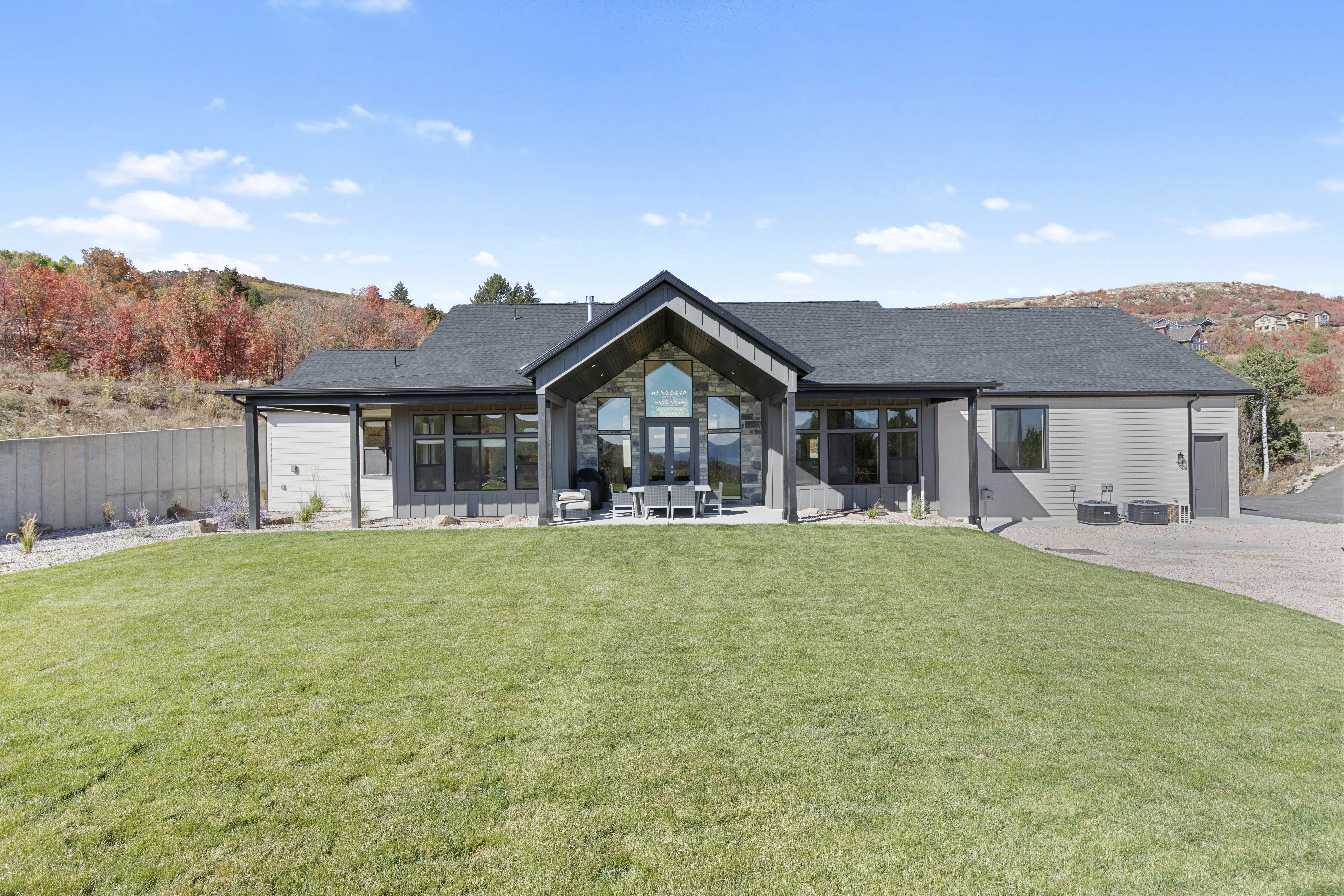 Back of property with a lawn and a patio area