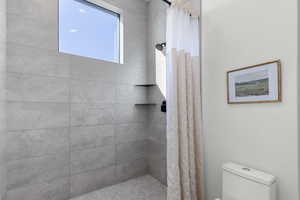 Full bathroom with a shower stall