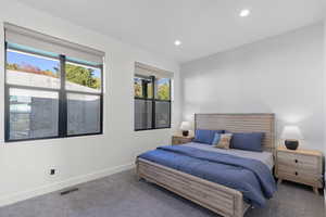 Carpeted bedroom with baseboards and recessed lighting
