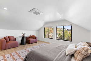 Bedroom featuring cooling unit, lofted ceiling, light wood-type flooring, and recessed lighting