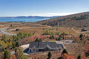 View from above of property with a water and mountain view