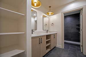 Bathroom featuring tile patterned flooring and vanity