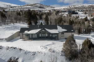 Snow covered property with a mountain view