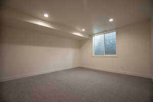 Empty room featuring dark carpet