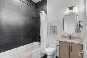 Full bath featuring shower / bath combo and vanity