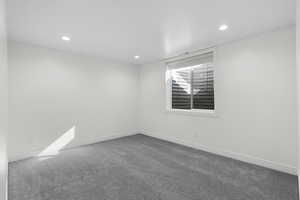 Spare room featuring carpet flooring and recessed lighting