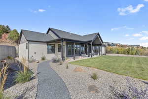 Rear view of property with a patio and roof with shingles