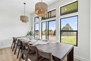 Dining area with a chandelier and light wood-type flooring