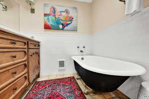 Bathroom with a bathtub, toilet, and tile patterned floors