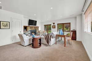 Carpeted living room featuring a fireplace