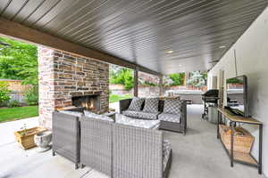 View of patio / terrace with an outdoor living space with a fireplace