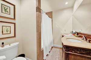 Full bathroom with shower / tub combo, toilet, and vanity