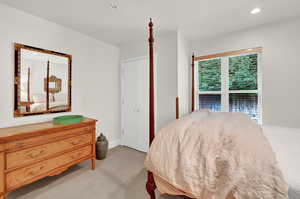 Carpeted bedroom with multiple windows