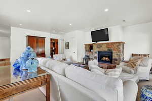 Carpeted living room featuring a fireplace