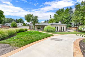 Single story home with a front lawn