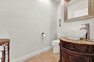 Bathroom with tile patterned floors, vanity, and toilet