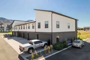 View of front of house with a garage and a mountain view