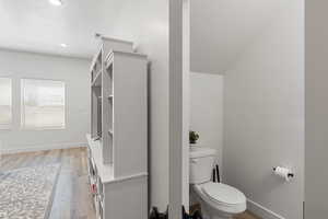 Bathroom with toilet and hardwood / wood-style flooring