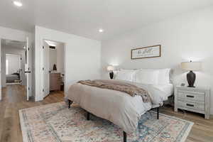 Bedroom featuring light wood-type flooring and connected bathroom