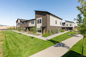 View of home's exterior featuring central AC and a lawn