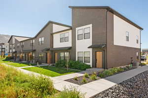 View of front of home featuring central air condition unit and a front lawn