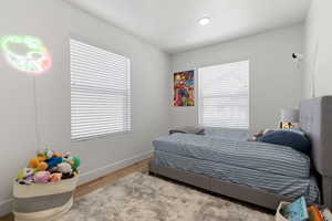 Bedroom with light hardwood / wood-style flooring