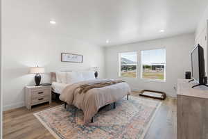 Bedroom with light hardwood / wood-style flooring