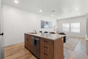 Kitchen featuring stainless steel appliances, light hardwood / wood-style floors, and a center island