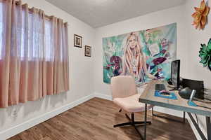 Office featuring a textured ceiling and wood-type flooring