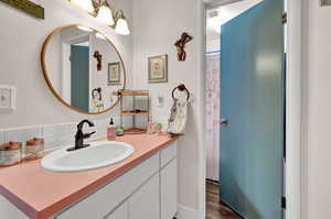 Bathroom with vanity and hardwood / wood-style floors