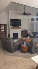 Living room with wood-type flooring, a textured ceiling, and ceiling fan