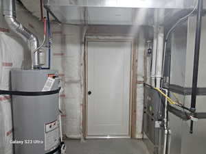 Utility room featuring water heater