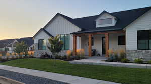 View of front of home featuring a lawn and covered porch