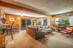 Living room featuring carpet floors and wooden walls