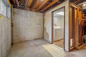 Basement featuring light hardwood / wood-style flooring and washing machine and clothes dryer