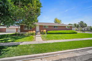 Single story home with a front lawn and a garage