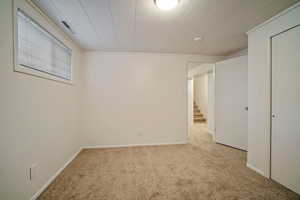 Unfurnished bedroom with light colored carpet